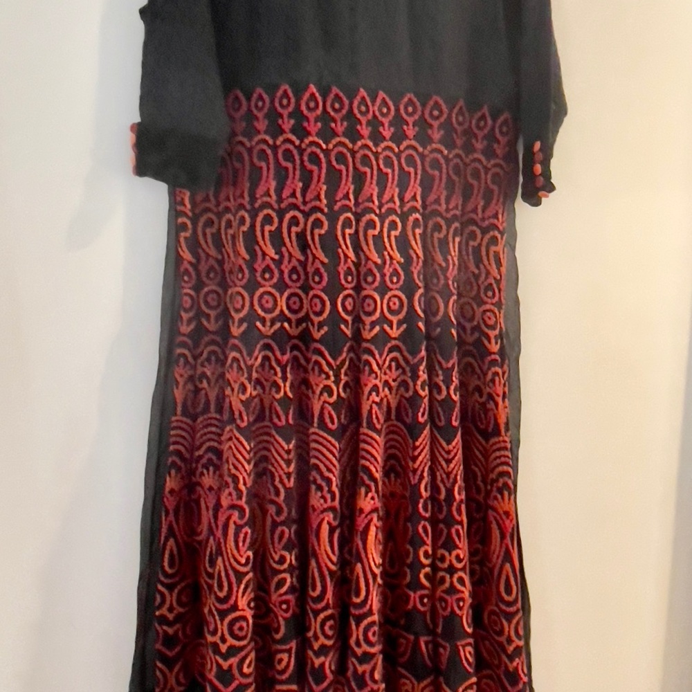 Black lace georgette ANARKALI with red and orange embroidery on it.